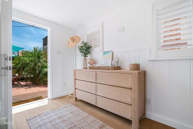 244 Cahuenga Dr, Oxnard, CA 93035 - bedroom with a decorative wall, access to exterior, wainscoting, and wood finished floors