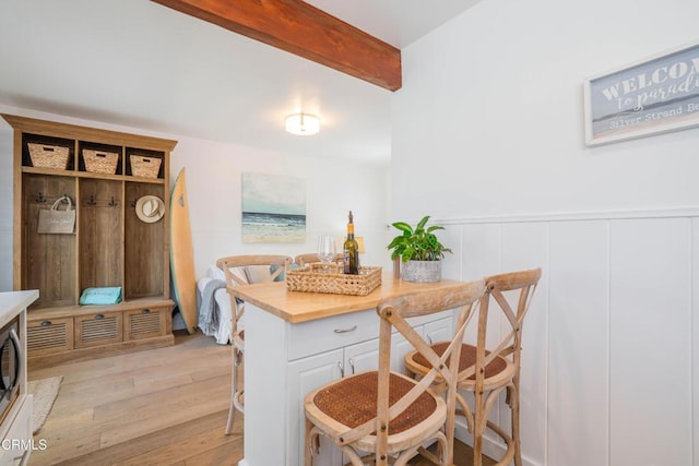244 Cahuenga Dr, Oxnard, CA 93035 - dining room featuring light wood-style flooring, beam ceiling, and wainscoting