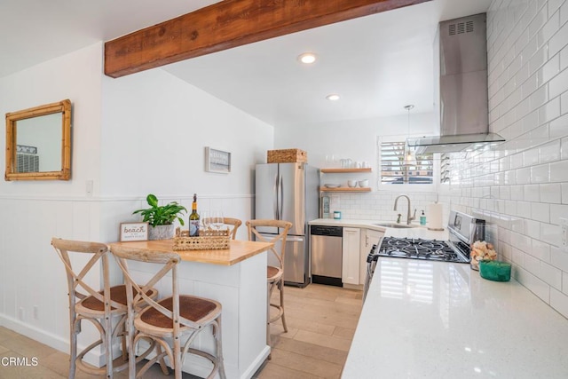 244 Cahuenga Dr, Oxnard, CA 93035 - kitchen featuring island range hood, appliances with stainless steel finishes, a breakfast bar area, a sink, and light countertops