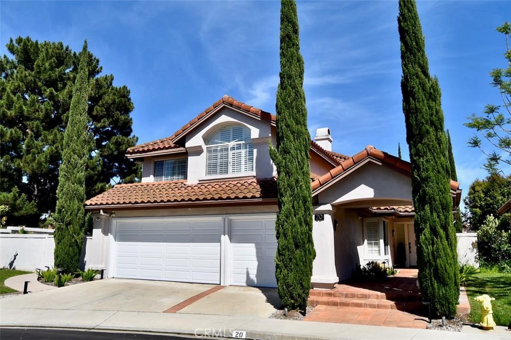 20 Salerno, Irvine, CA 92614 - mediterranean / spanish-style home featuring driveway, an attached garage, a tile roof, and a chimney