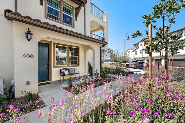 466 Besalu, Mission Viejo, CA 92692 - property entrance featuring covered porch, stucco siding, a tile roof, and a residential view