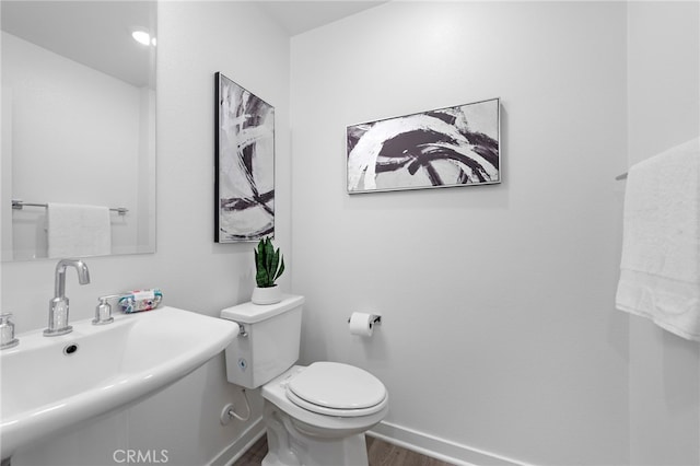 466 Besalu, Mission Viejo, CA 92692 - half bath with wood finished floors, a sink, toilet, and baseboards