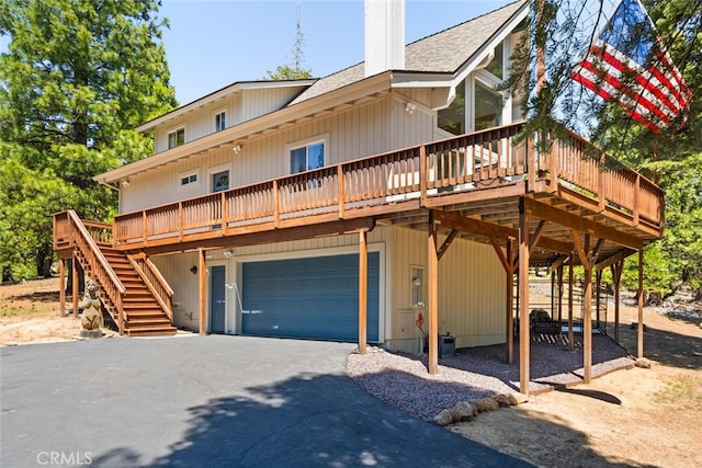 120 Top Of The W Dr, Chester, CA 96020 - rustic home with a garage, driveway, a wooden deck, a shingled roof, and a chimney