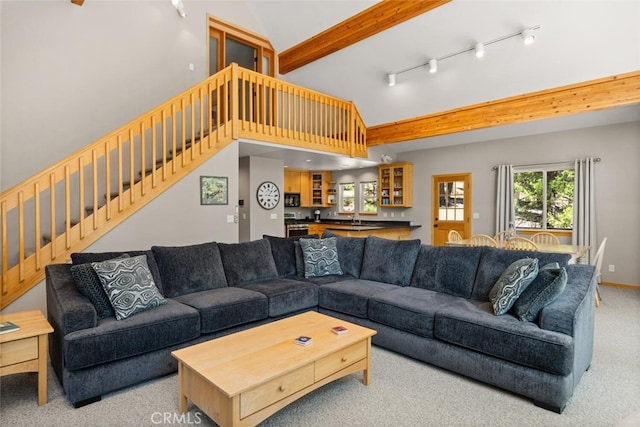 120 Top Of The W Dr, Chester, CA 96020 - carpeted living room featuring healthy amount of natural light, stairs, rail lighting, vaulted ceiling, and a sink