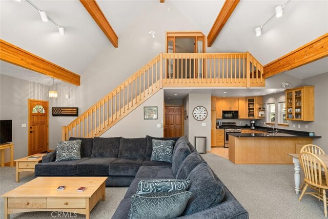 120 Top Of The W Dr, Chester, CA 96020 - living area with track lighting, light carpet, beamed ceiling, high vaulted ceiling, and stairway