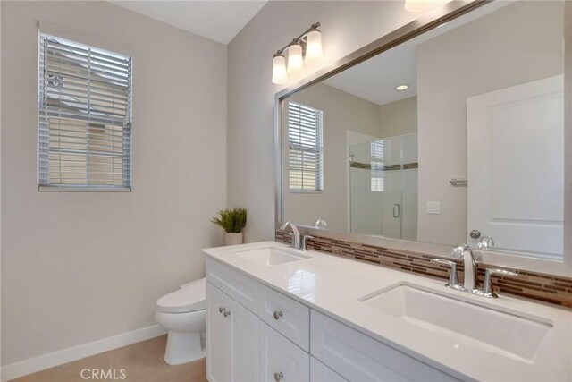 908 N Alameda Ave, Azusa, CA 91702 - full bathroom with toilet, a stall shower, double vanity, and baseboards