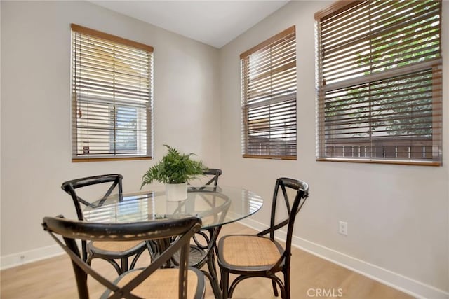 908 N Alameda Ave, Azusa, CA 91702 - dining area with baseboards, plenty of natural light, and light wood-style floors