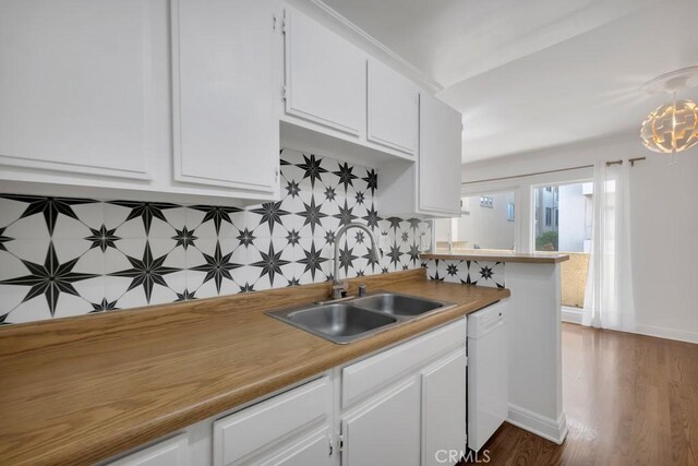 1020 Granville Ave Unit 205, Los Angeles, CA 90049 - kitchen with white dishwasher, white cabinetry, and backsplash