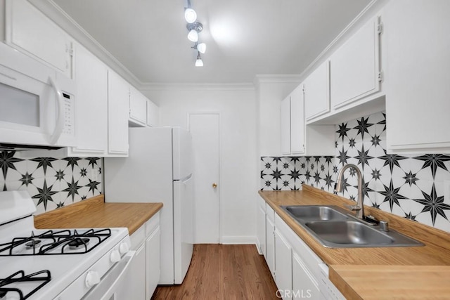 1020 Granville Ave Unit 205, Los Angeles, CA 90049 - kitchen with white appliances, decorative backsplash, white cabinets, light countertops, and ornamental molding