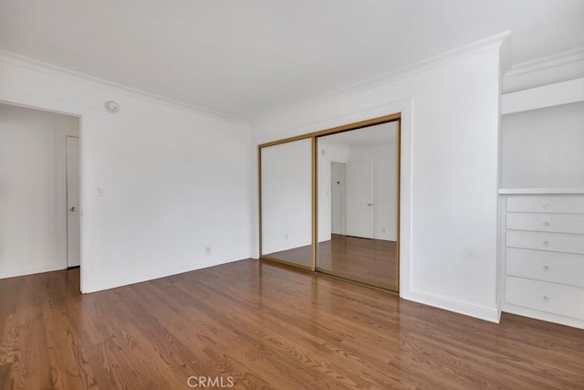 1020 Granville Ave Unit 205, Los Angeles, CA 90049 - unfurnished bedroom with ornamental molding, wood finished floors, and a closet