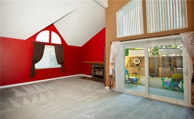 5515 Katrina Pl, Palmdale, CA 93552 - unfurnished living room featuring high vaulted ceiling, carpet floors, healthy amount of natural light, and a fireplace with flush hearth