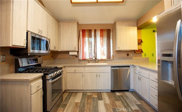 5515 Katrina Pl, Palmdale, CA 93552 - kitchen featuring appliances with stainless steel finishes, light countertops, light wood finished floors, and light brown cabinets