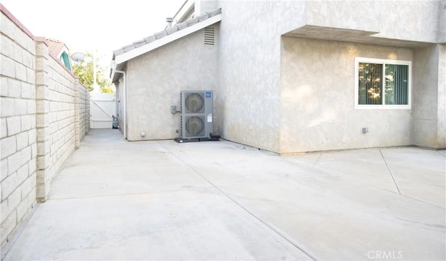 5515 Katrina Pl, Palmdale, CA 93552 - view of property exterior with stucco siding, a patio, and a gate