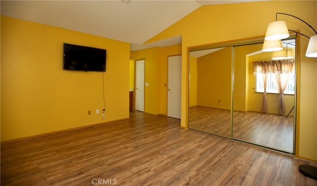 5515 Katrina Pl, Palmdale, CA 93552 - unfurnished bedroom with wood finished floors, vaulted ceiling, and a closet