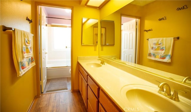 5515 Katrina Pl, Palmdale, CA 93552 - full bathroom with double vanity, wood finished floors, and shower / bathtub combination
