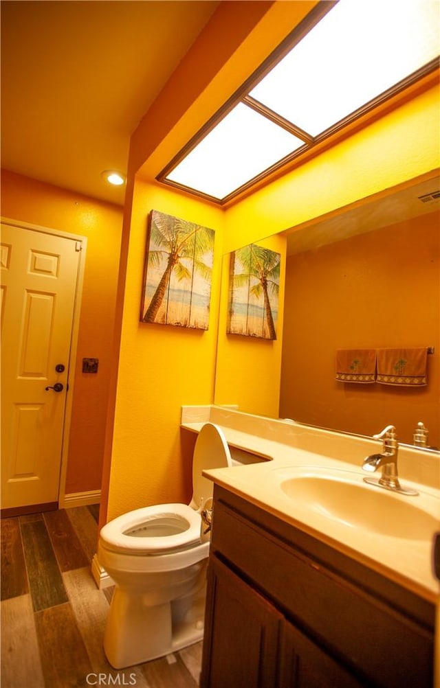 5515 Katrina Pl, Palmdale, CA 93552 - bathroom featuring vanity, wood finished floors, and recessed lighting