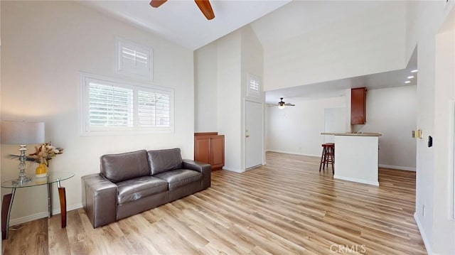 24420 Flaxwood Ln Unit 204, Newhall, CA 91321 - sitting room with a ceiling fan, light wood finished floors, high vaulted ceiling, and baseboards