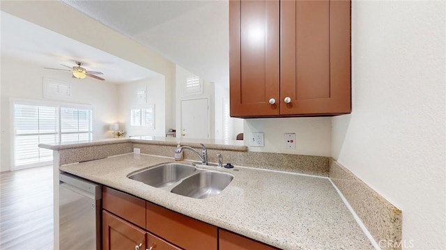 24420 Flaxwood Ln Unit 204, Newhall, CA 91321 - kitchen with dishwasher, a sink, open floor plan, a ceiling fan, and brown cabinetry