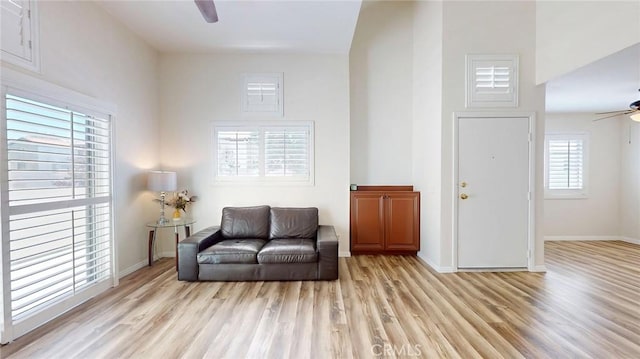 24420 Flaxwood Ln Unit 204, Newhall, CA 91321 - living area featuring a ceiling fan, light wood finished floors, and baseboards