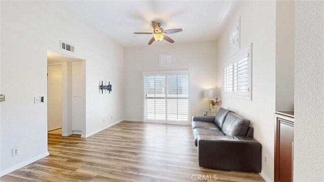 24420 Flaxwood Ln Unit 204, Newhall, CA 91321 - living area featuring a ceiling fan, wood finished floors, and baseboards