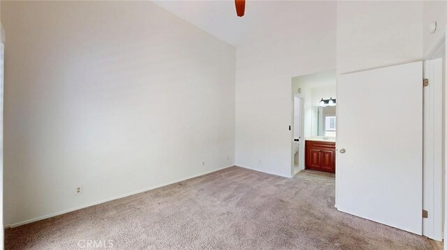 24420 Flaxwood Ln Unit 204, Newhall, CA 91321 - unfurnished bedroom with light colored carpet, baseboards, connected bathroom, and a ceiling fan