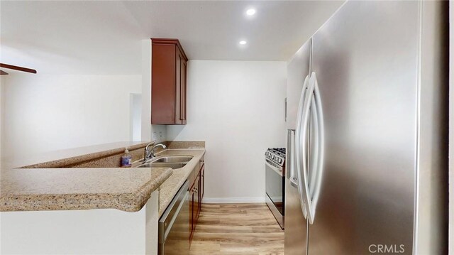 24420 Flaxwood Ln Unit 204, Newhall, CA 91321 - kitchen with stainless steel appliances, a sink, light wood finished floors, recessed lighting, and ceiling fan