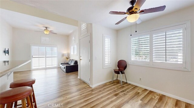 24420 Flaxwood Ln Unit 204, Newhall, CA 91321 - living area featuring light wood-style flooring, a ceiling fan, and baseboards