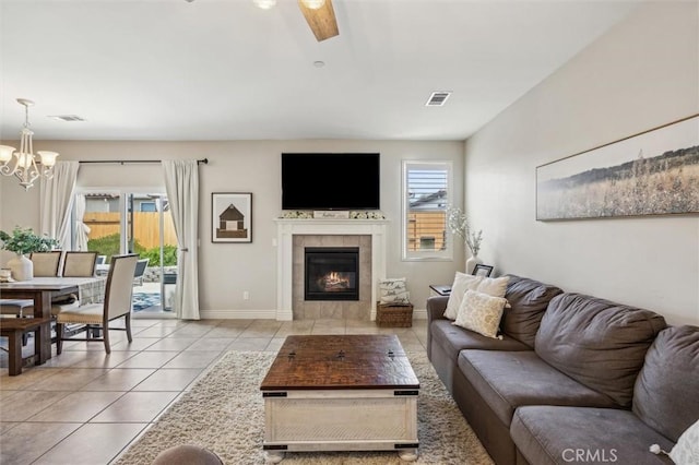 255 Waterfall Rd, Templeton, CA 93465 - living room with light tile patterned flooring, a chandelier, a tiled fireplace, ceiling fan, and baseboards