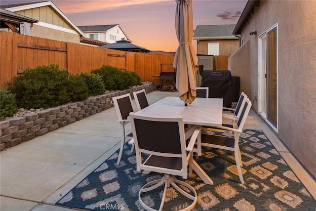 255 Waterfall Rd, Templeton, CA 93465 - patio terrace at dusk featuring a patio, outdoor dining space, a fenced backyard, and a grill