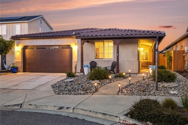 255 Waterfall Rd, Templeton, CA 93465 - view of front facade featuring a tile roof, stucco siding, a garage, and concrete driveway