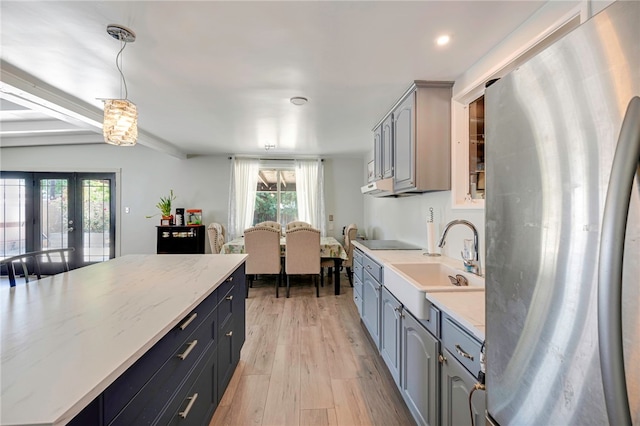 1111 W Berkeley Ct, Ontario, CA 91762 - kitchen with freestanding refrigerator, a sink, plenty of natural light, light wood finished floors, and recessed lighting