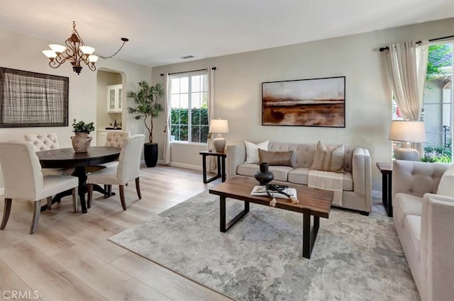 19 Laurelhurst Dr, Ladera Ranch, CA 92694 - living area featuring light wood finished floors, plenty of natural light, baseboards, and arched walkways