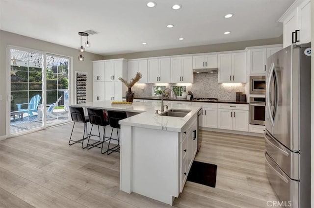 19 Laurelhurst Dr, Ladera Ranch, CA 92694 - kitchen featuring appliances with stainless steel finishes, a sink, decorative backsplash, white cabinets, and recessed lighting