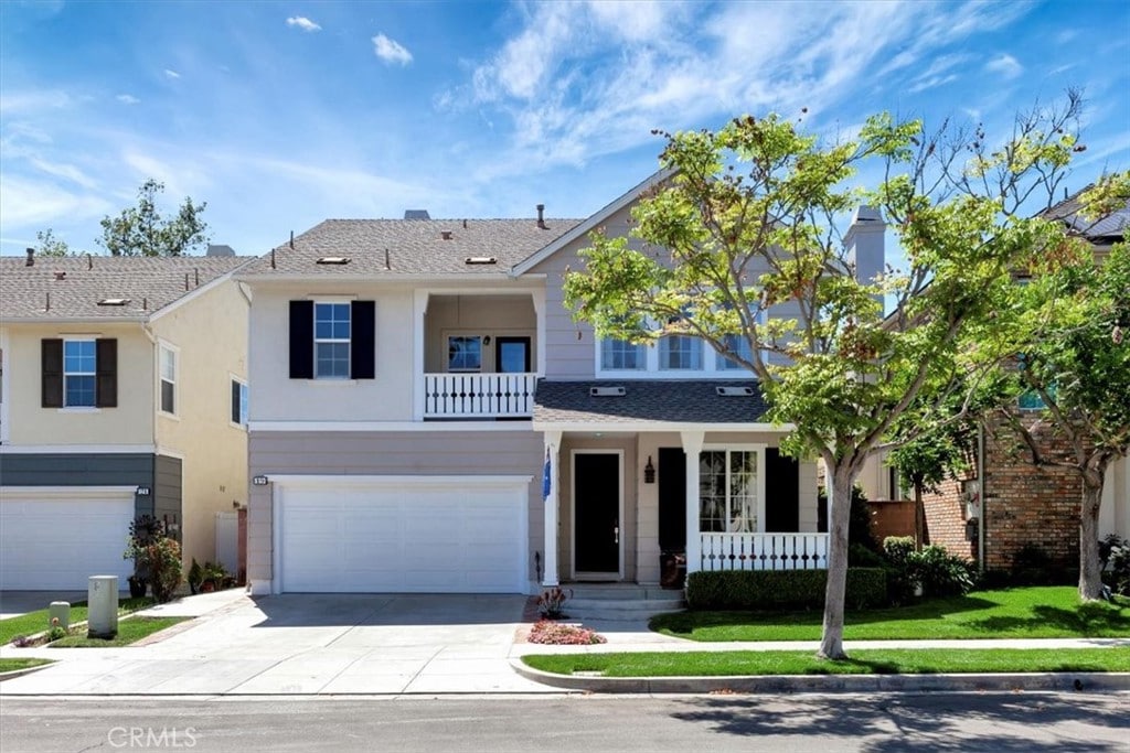 19 Laurelhurst Dr, Ladera Ranch, CA 92694 - view of front of house featuring driveway, an attached garage, a porch, stucco siding, and roof with shingles