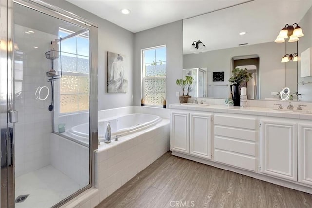 19 Laurelhurst Dr, Ladera Ranch, CA 92694 - bathroom featuring a bath, a stall shower, double vanity, wood finished floors, and recessed lighting