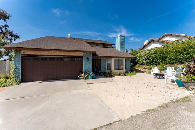1520 Downs St, Oceanside, CA 92054 - view of front facade with an attached garage, concrete driveway, a shingled roof, and a chimney