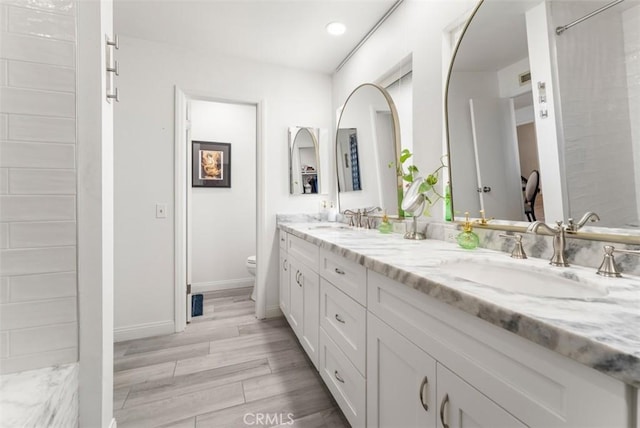 1520 Downs St, Oceanside, CA 92054 - full bathroom with double vanity, toilet, wood finished floors, baseboards, and recessed lighting