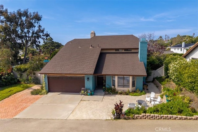 1520 Downs St, Oceanside, CA 92054 - view of front of home with an attached garage, a shingled roof, driveway, and a chimney