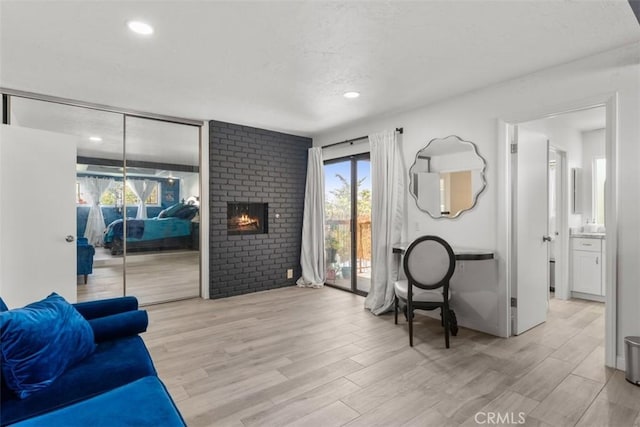 1520 Downs St, Oceanside, CA 92054 - living area with healthy amount of natural light, light wood-style flooring, recessed lighting, and a brick fireplace