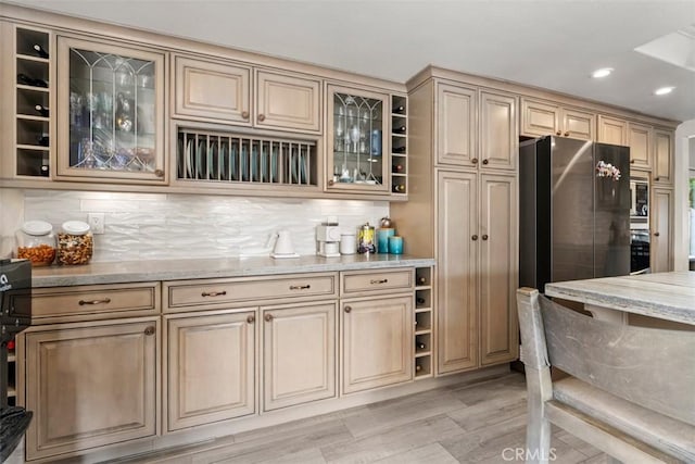 1520 Downs St, Oceanside, CA 92054 - kitchen with freestanding refrigerator, light stone counters, light wood-style floors, backsplash, and recessed lighting