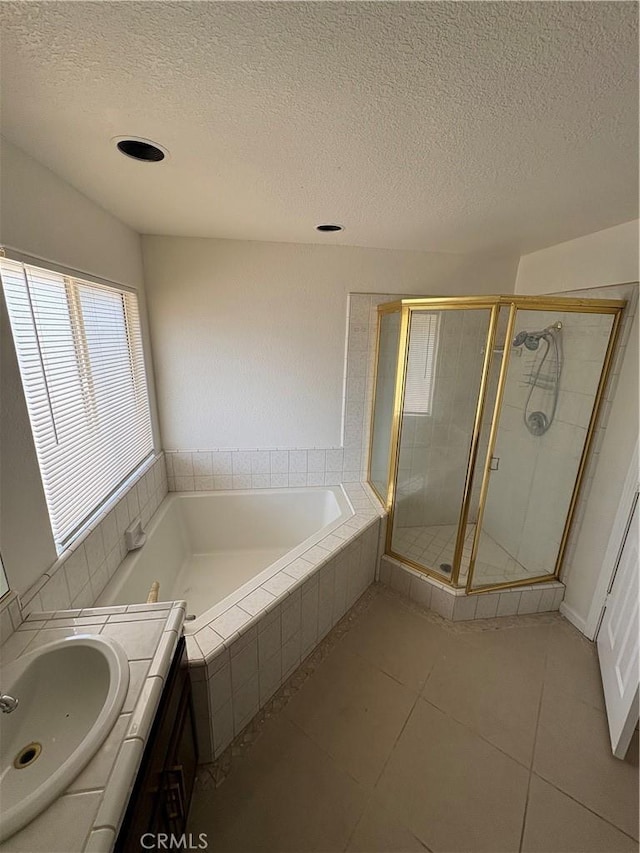 17930 Main St, Hesperia, CA 92345 - bathroom featuring a garden tub, a stall shower, tile patterned flooring, a textured ceiling, and vanity