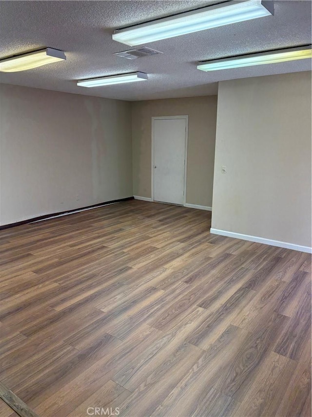 17930 Main St, Hesperia, CA 92345 - spare room with wood finished floors, a textured ceiling, and baseboards