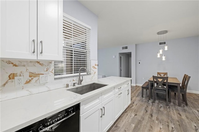 20000 Plum Canyon Rd Unit 1326, Saugus, CA 91350 - kitchen featuring a sink, dishwasher, tasteful backsplash, white cabinetry, and light stone countertops