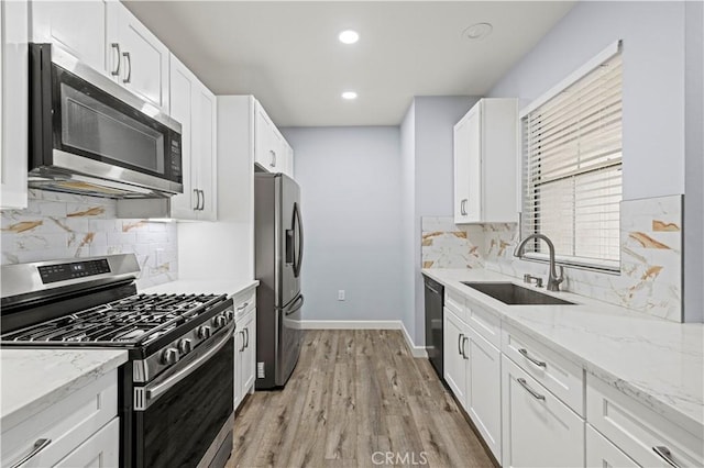 20000 Plum Canyon Rd Unit 1326, Saugus, CA 91350 - kitchen with appliances with stainless steel finishes, a sink, white cabinetry, light wood-style flooring, and recessed lighting