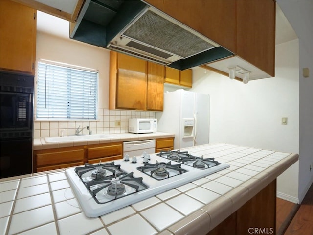 3819 W 190th St, Torrance, CA 90504 - kitchen featuring tile countertops, white appliances, exhaust hood, a sink, and decorative backsplash