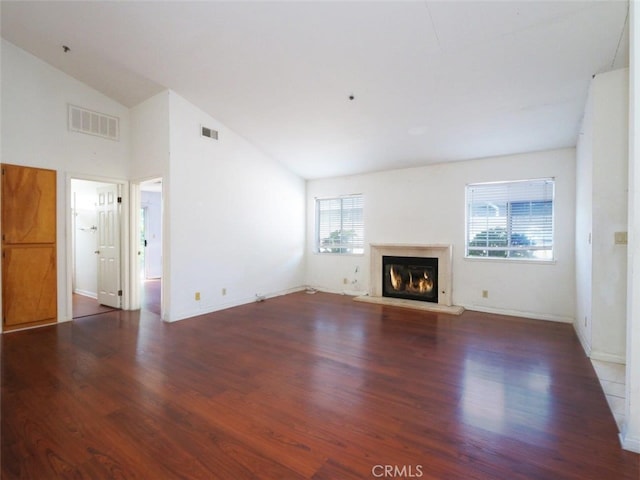 3819 W 190th St, Torrance, CA 90504 - unfurnished living room featuring healthy amount of natural light, wood finished floors, a glass covered fireplace, baseboards, and high vaulted ceiling