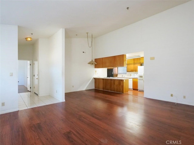 3819 W 190th St, Torrance, CA 90504 - unfurnished living room featuring light wood-style floors and a towering ceiling
