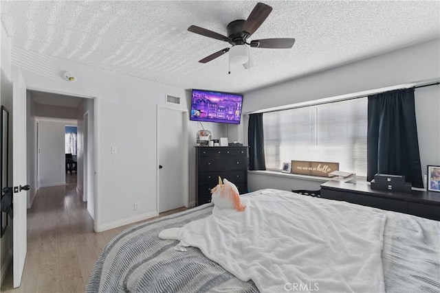 1089 E Columbia Ave, Pomona, CA 91767 - bedroom with a textured ceiling, light wood-type flooring, ceiling fan, and baseboards