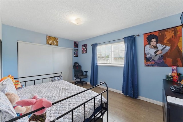 1089 E Columbia Ave, Pomona, CA 91767 - bedroom with wood finished floors, a textured ceiling, baseboards, and a closet