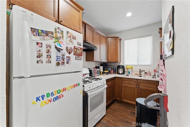 1089 E Columbia Ave, Pomona, CA 91767 - kitchen featuring white appliances, dark wood-style floors, under cabinet range hood, a sink, and light countertops